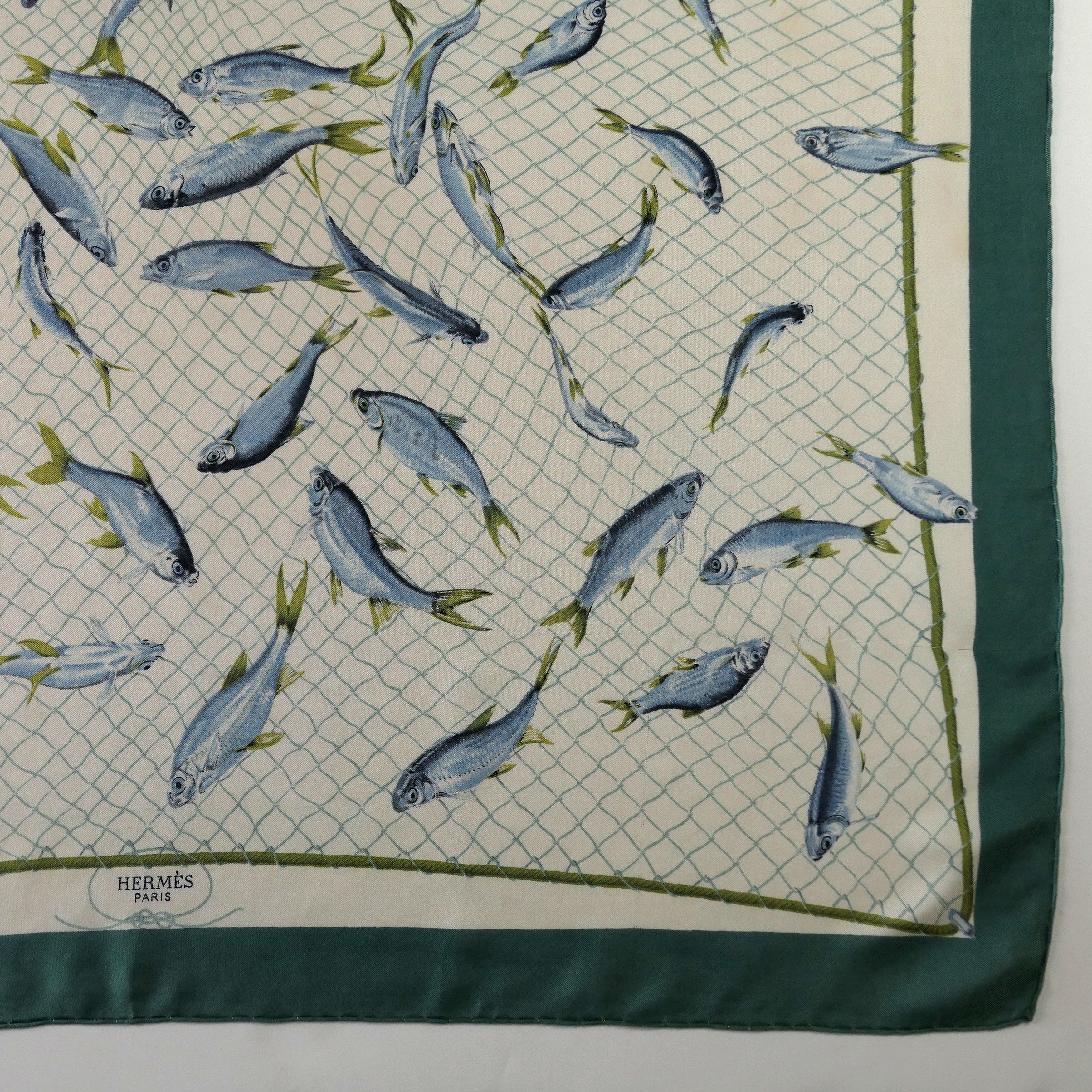 Carré Hermès Coup de Filet 90 cm soie, détail bordure verte et signature Hermès Paris