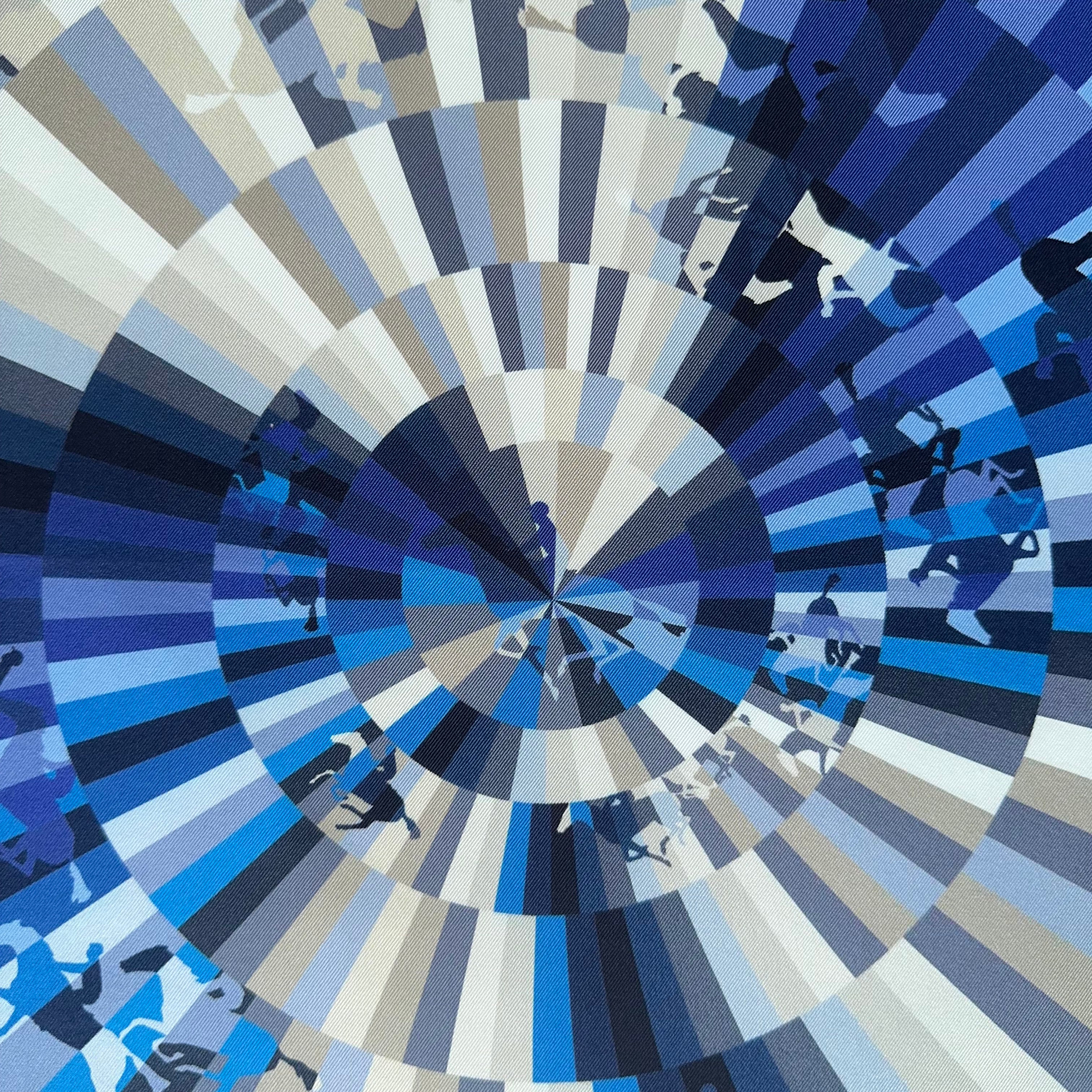 Zoom plongeant sur le centre du foulard "vortex" où les rayons de couleurs se rejoignent, illustrant la précision de l'impression Hermès.